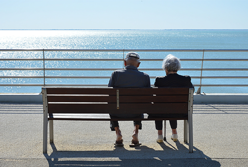 Senior couple sitting on a wooden bench