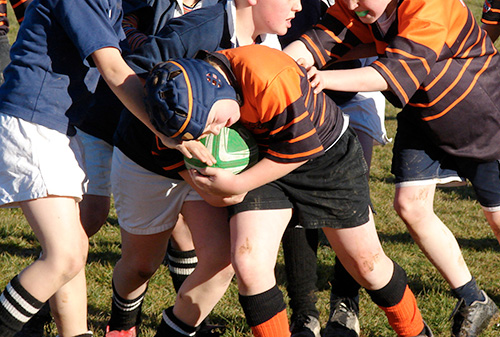 Schoolboy playing rugby