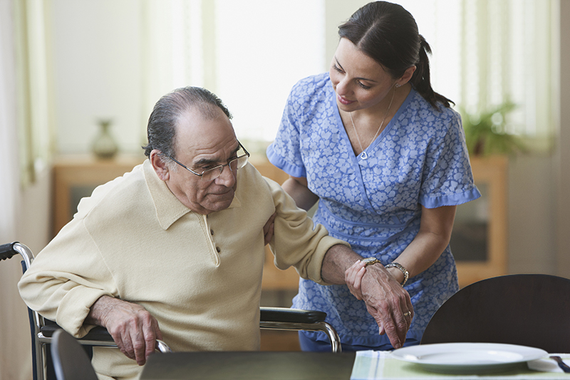 Nurse helping elderly man
