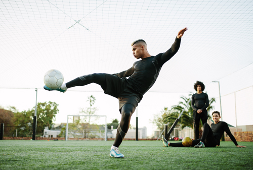 Footballer kicking ball