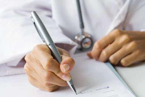 Doctor signing forms