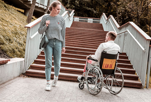 Young woman looking at disabled man